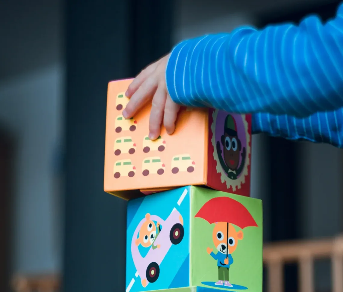 child building an four boxes