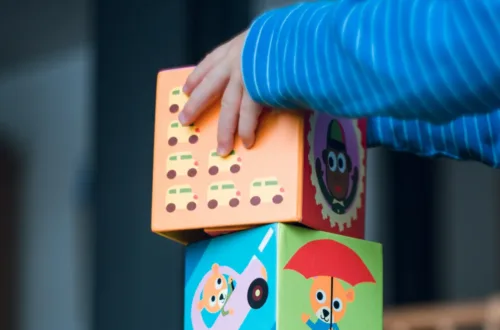 child building an four boxes